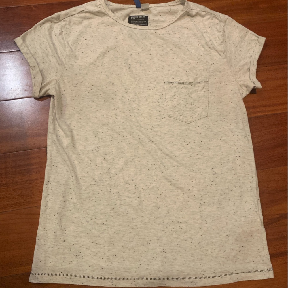 Divided-This shirt has a front pocket. Black Dots all over the shirt.Must bundle